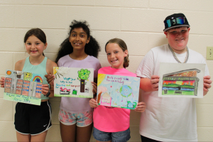  students holding their winning posters